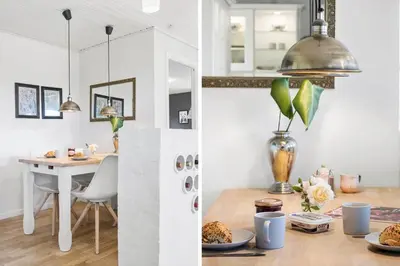 a kitchen and a dining room with a table with plates of food at BL1206-Blokhus-Blaabaervej-6 in Blokhus