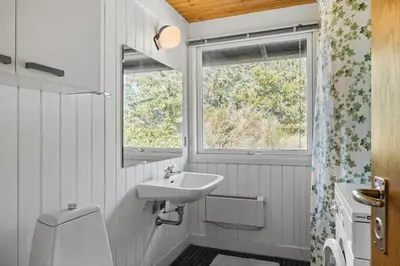 a white bathroom with a sink and a window at BL1677-Saltum-Sikahjortvej-6 in Saltum