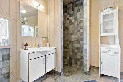 a bathroom with a sink and a mirror at BL1700-Blokhus-Bloksbjerg-55 in Blokhus