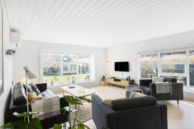 a living room with two couches and a tv at BL1680-Blokhus-Klitgaardsvej-18 in Blokhus