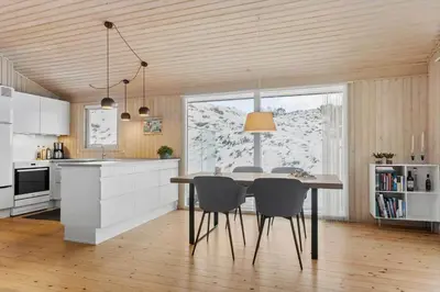 a kitchen with a dining room table and chairs at BL1620-Saltum-Foraarsvangen-7 in Saltum