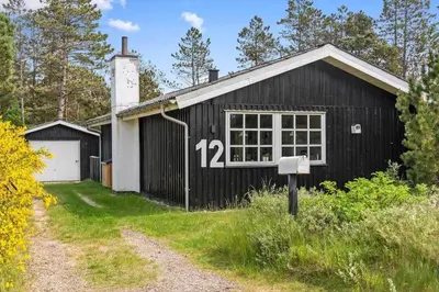 a black building with the number on it at BL1082-Blokhus-Klintevej-12 in Blokhus