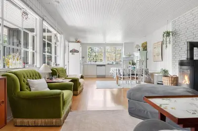 a living room with two green chairs and a table at BL1082-Blokhus-Klintevej-12 in Blokhus