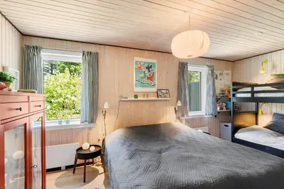 a bedroom with a bed and a bunk bed at BL1666-Saltum-Vikingebanke-5 in Saltum