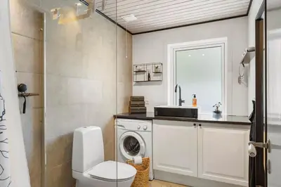 a bathroom with a washing machine and a sink at BL1666-Saltum-Vikingebanke-5 in Saltum