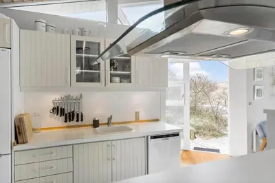a kitchen with white cabinets and a sink at BL1156-Blokhus-Ankerhusvej-44 in Blokhus