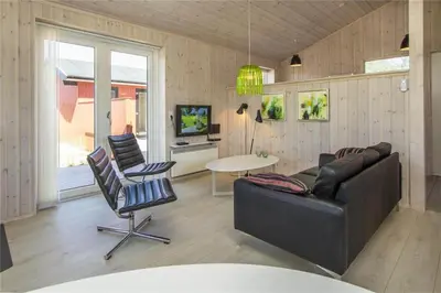 a living room with a couch and a table and chairs at BL117-Pandrup-Marsvinet-30 in Pandrup
