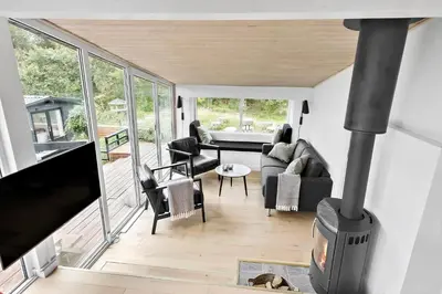 a living room with a fireplace in a house at BL1335-Blokhus-Havorns-Alle-32 in Blokhus