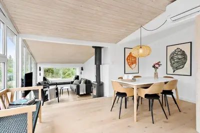 a dining room and living room with a table and chairs at BL1335-Blokhus-Havorns-Alle-32 in Blokhus