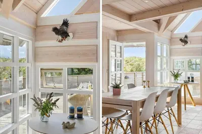 a dining room with a table and chairs and windows at BL1647-Saltum-Graabakken-46 in Saltum
