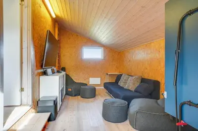 a living room with a couch and a tv at BL813-Blokhus-Klitvejen-12 in Blokhus
