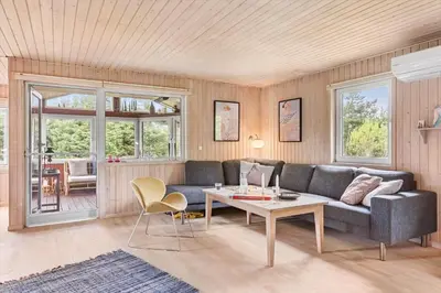 a living room with a couch and a table at BL1332-Pandrup-Rodhusparken-78 in Pandrup