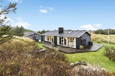 a small black house on a wooden deck at BL1767-Saltum-Saltum-Strandvej-209 in Saltum