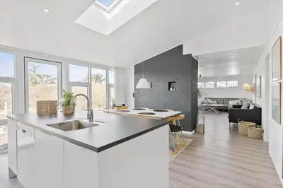 a kitchen with a sink and a living room at BL1767-Saltum-Saltum-Strandvej-209 in Saltum