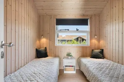 two beds in a room with a window at BL806-Saltum-Laustvej-8 in Saltum