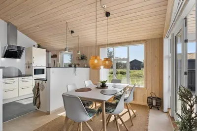 a kitchen and dining room with a table and chairs at BL806-Saltum-Laustvej-8 in Saltum