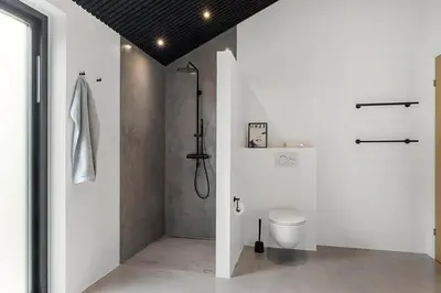 a white bathroom with a toilet and a shower at BL1364-Saltum-Tolhoj-34 in Saltum