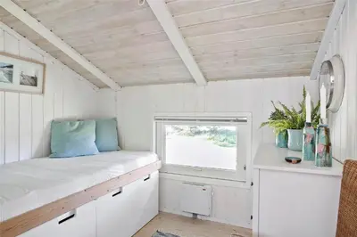 a small white room with a window and a bench at BL583-Saltum-Saltum-Strandvej-210 in Saltum