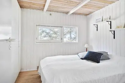a white bedroom with a bed and a window at BL583-Saltum-Saltum-Strandvej-210 in Saltum