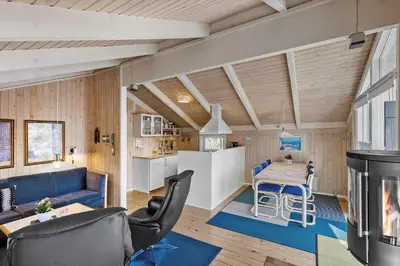 a kitchen and living room with a table and chairs at BL331-Saltum-Ornebjergvej-21 in Saltum