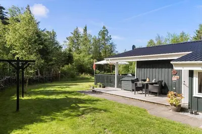 a backyard with a patio and a house at BL1466-Pandrup-Lunekrogen-14 in Pandrup