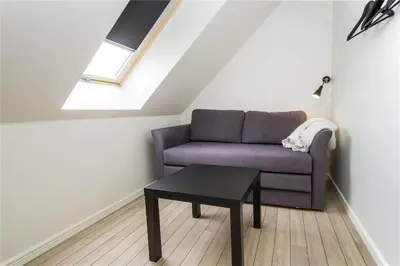 a living room with a purple couch and a table at BL139-Blokhus-Klitvejen-4-A in Blokhus