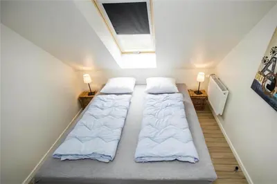 two beds in a small room with two lights at BL139-Blokhus-Klitvejen-4-A in Blokhus