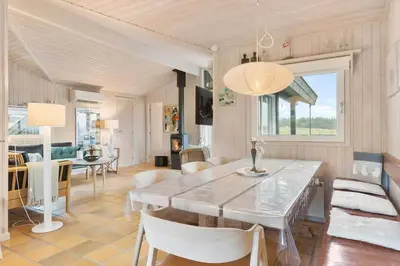 a dining room and living room with a table and chairs at BL203-Saltum-Karen-Mariesvej-67 in Saltum