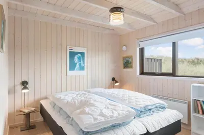 a bedroom with a bed in a room with a window at BL1591-Pandrup-Ferborgvej-54 in Pandrup