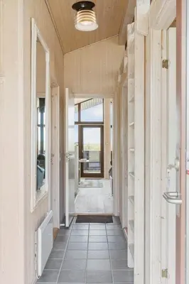 a hallway in a house with a hallway leading to a door at BL1591-Pandrup-Ferborgvej-54 in Pandrup