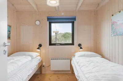 two beds in a room with a window at BL1591-Pandrup-Ferborgvej-54 in Pandrup