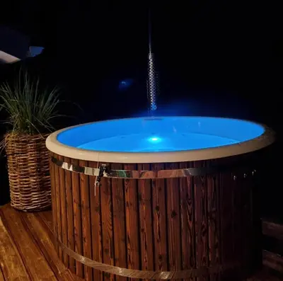a hot tub in a wooden barrel with a fountain at BL1762-Blokhus-Bloksbjerg-22 in Blokhus