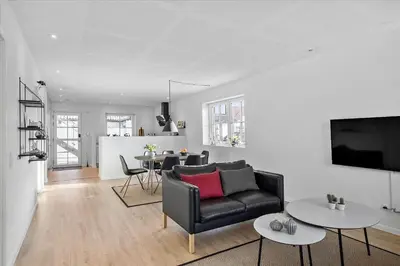 a living room with a couch and a table at BL1520-Blokhus-Klitgaardsvej-3-B in Blokhus