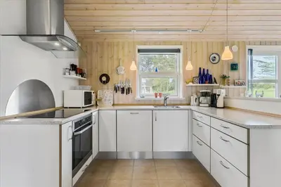 a kitchen with white cabinets and white appliances at BL1715-Saltum-Kvansletten-15 in Saltum