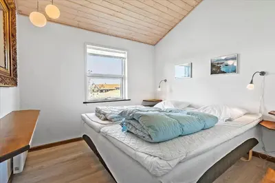 a large bed in a room with a window at BL411-Pandrup-Hunetorp-Klitvej-223 in Pandrup