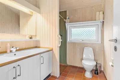 a bathroom with a toilet and a sink at BL1696-Saltum-Kordalslien-9 in Saltum