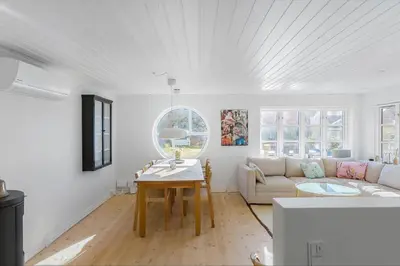 a white living room with a couch and a table at BL1527-Blokhus-Svinget-5 in Blokhus