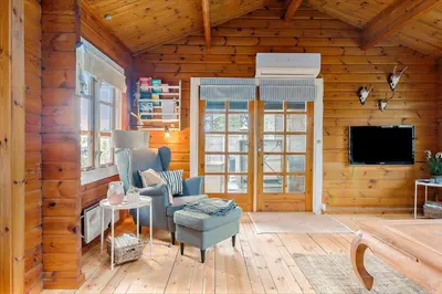 a living room with wooden walls and a flat screen tv at BL969-Blokhus-Bregnehojvej-16 in Blokhus
