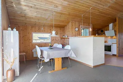 a kitchen and dining room with a table and chairs at BL469-Pandrup-Hunetorp-Klitvej-179 in Pandrup