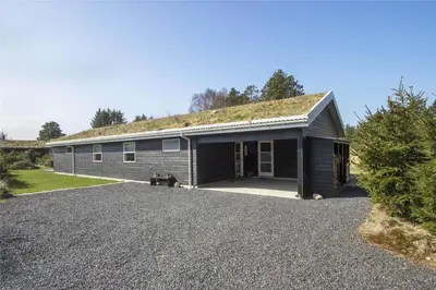 a house with a roof with a gravel driveway at BL1134-Blokhus-Bloksbjerg-17-B in Blokhus