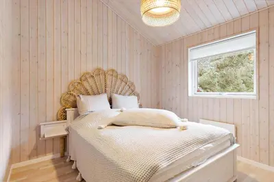 a bedroom with a large bed and a window at BL1328-Saltum-Kvanbaekvej-33 in Saltum