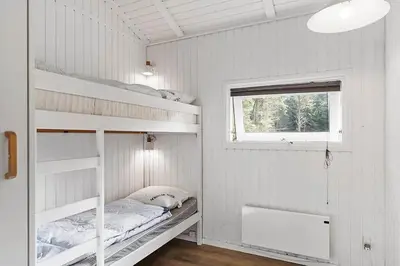 a bedroom with two bunk beds and a window at BL1654-Saltum-Ornebjergvej-11 in Saltum