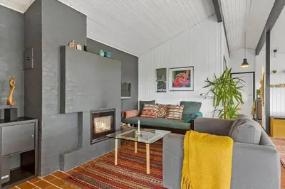 a living room with a couch and a fireplace at BL1473-Pandrup-Lommelaerken-14 in Pandrup