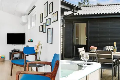 a dining room with blue chairs and a dining table at BL1377-Blokhus-Valmuemarken-37 in Blokhus