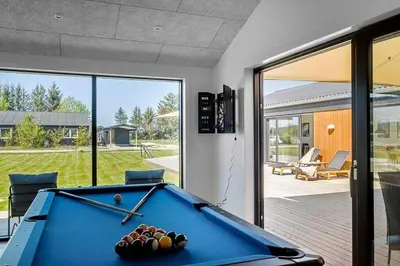 a pool table in a room with sliding glass doors at BL1257-Saltum-Vesterhavs-Sletten-35 in Saltum