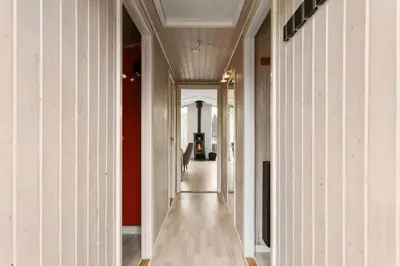 a hallway of a building with white walls and wood floors at BL1218-Blokhus-Quintusvej-24 in Blokhus