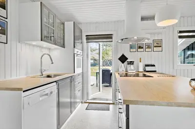 a kitchen with white cabinets and a wooden counter top at BL1029-Pandrup-Rodhus-Skolevej-9 in Pandrup