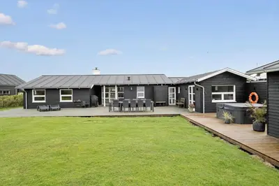 a house with a large yard in front of it at BL709-Blokhus-Kr-Thomsensvej-5 in Blokhus