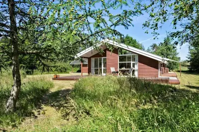 a small red house in the middle of a field at BL1727-Pandrup-Lunekrogen-16 in Pandrup