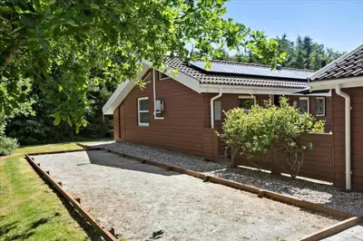 a house with a garden in front of it at BL1727-Pandrup-Lunekrogen-16 in Pandrup